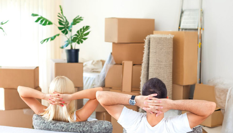 A woman and man are relaxing on sofa